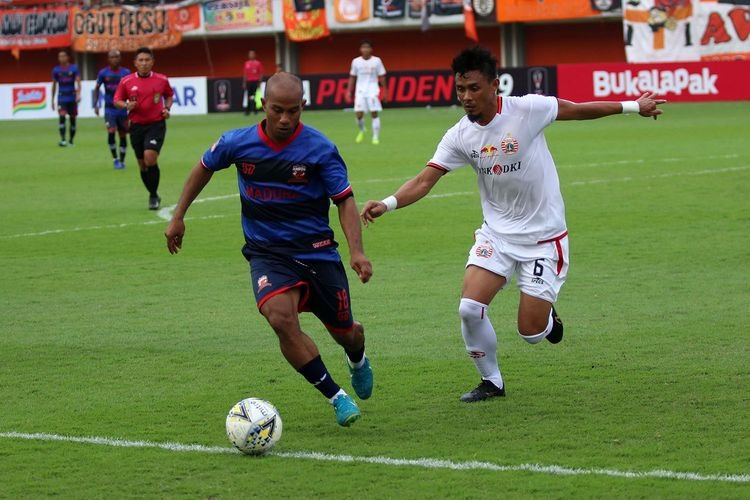Bek Persija Jakarta Maman Andurahman menempe ketat pemain Madura United Rinto Ali di pertandingan Piala Presiden di Stadion Maguwoharjo. (Foto: OLens.id/Gonang Susatyo)